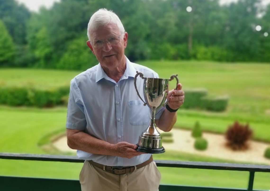 Golf day winner with trophy