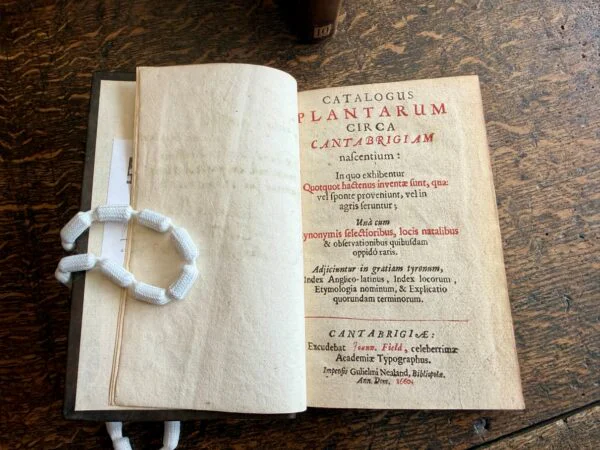 A book open showing text in Latin on the righthandside. 