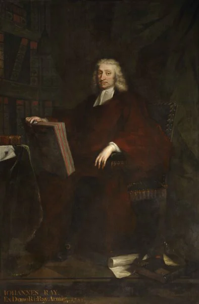 Dark painting of a middle-aged man in red robes holding a large book upright on his knee. 