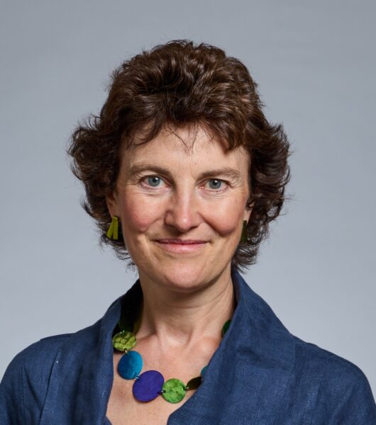 Headshot of woman in blue shirt.