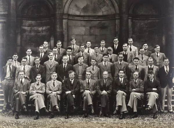 Group of men formally attired for a photoshoot. 