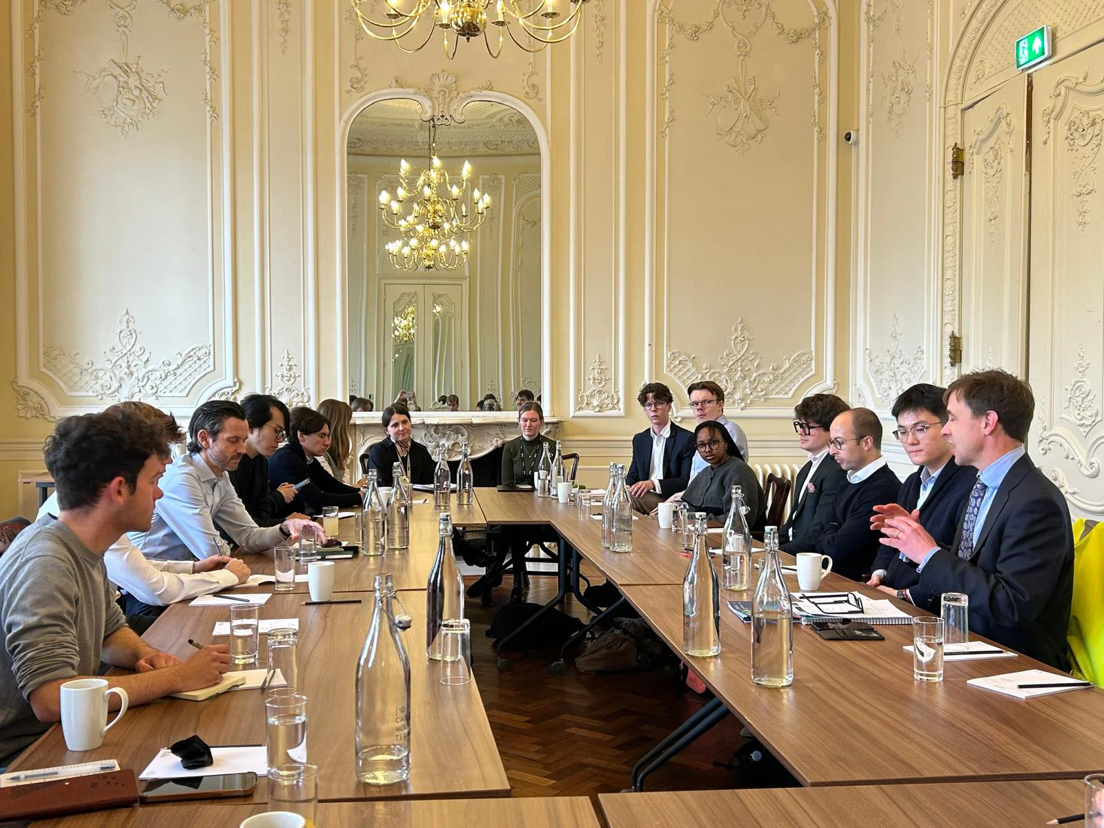 Group in discussion around a table for the Trinity Policy Programme.