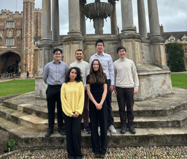 A group of young students in front of a fountain. 